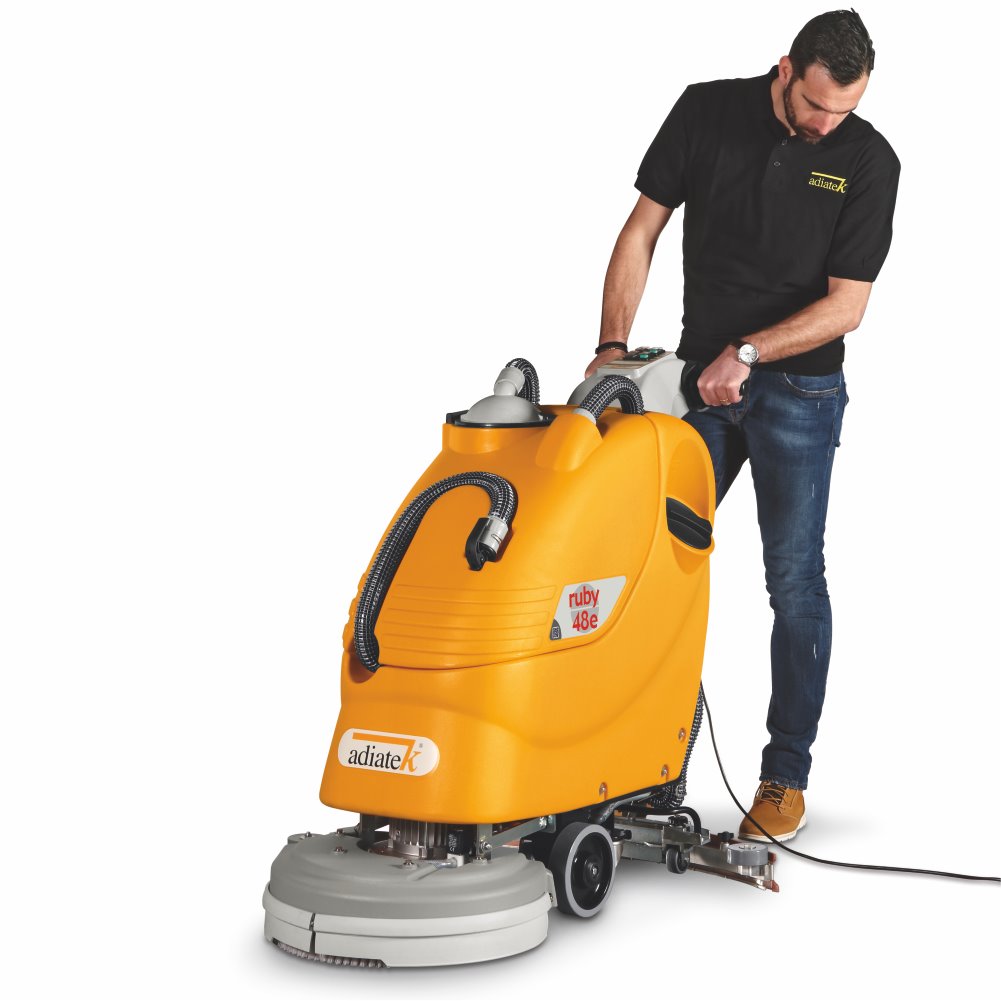 Person operating a yellow Adiatek Ruby 48e Electric Auto Scrubber machine on a white background