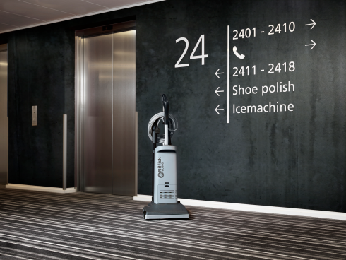 Nilfisk VU500 Upright Vacuum Cleaner 15" in lift foyer.