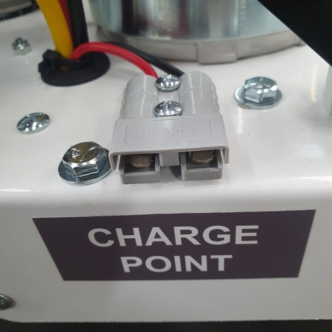 Close-up of a charging point with visible wiring and 'CHARGE POINT' label.