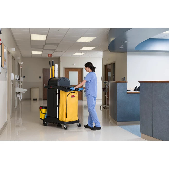 Person pushing a Rubbermaid High Security Cleaning Cart with supplies in a hospital setting