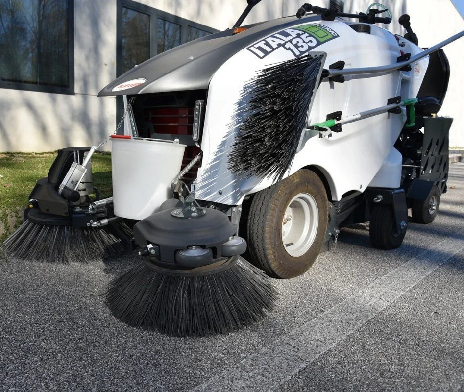 Street cleaning machine with brushes on a road