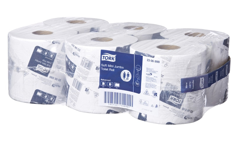 Multiple Tork toilet paper rolls stacked on a white background