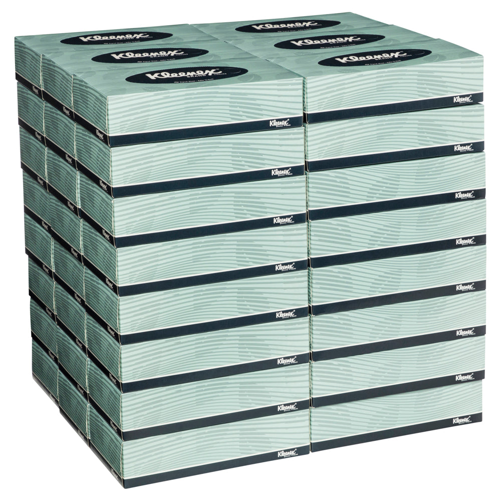 Stack of Kleenex facial tissue boxes on a white background