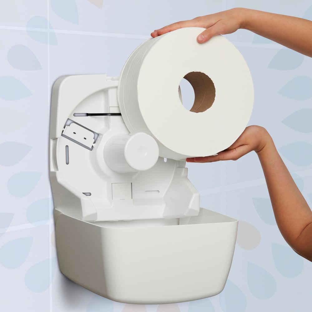 White paper towel holder with a roll of paper towels being added against a light blue background