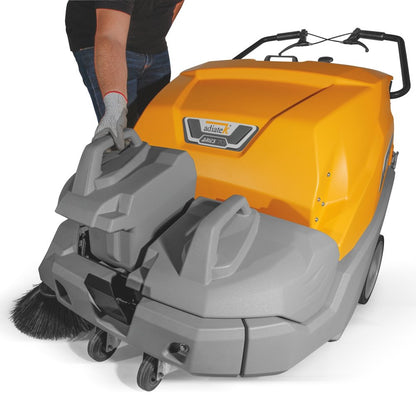 Orange and gray floor cleaning machine with a person partially visible