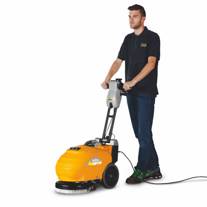 Person using a Adiatek Baby-e 33cm Floor Scrubber Corded machine on a white background