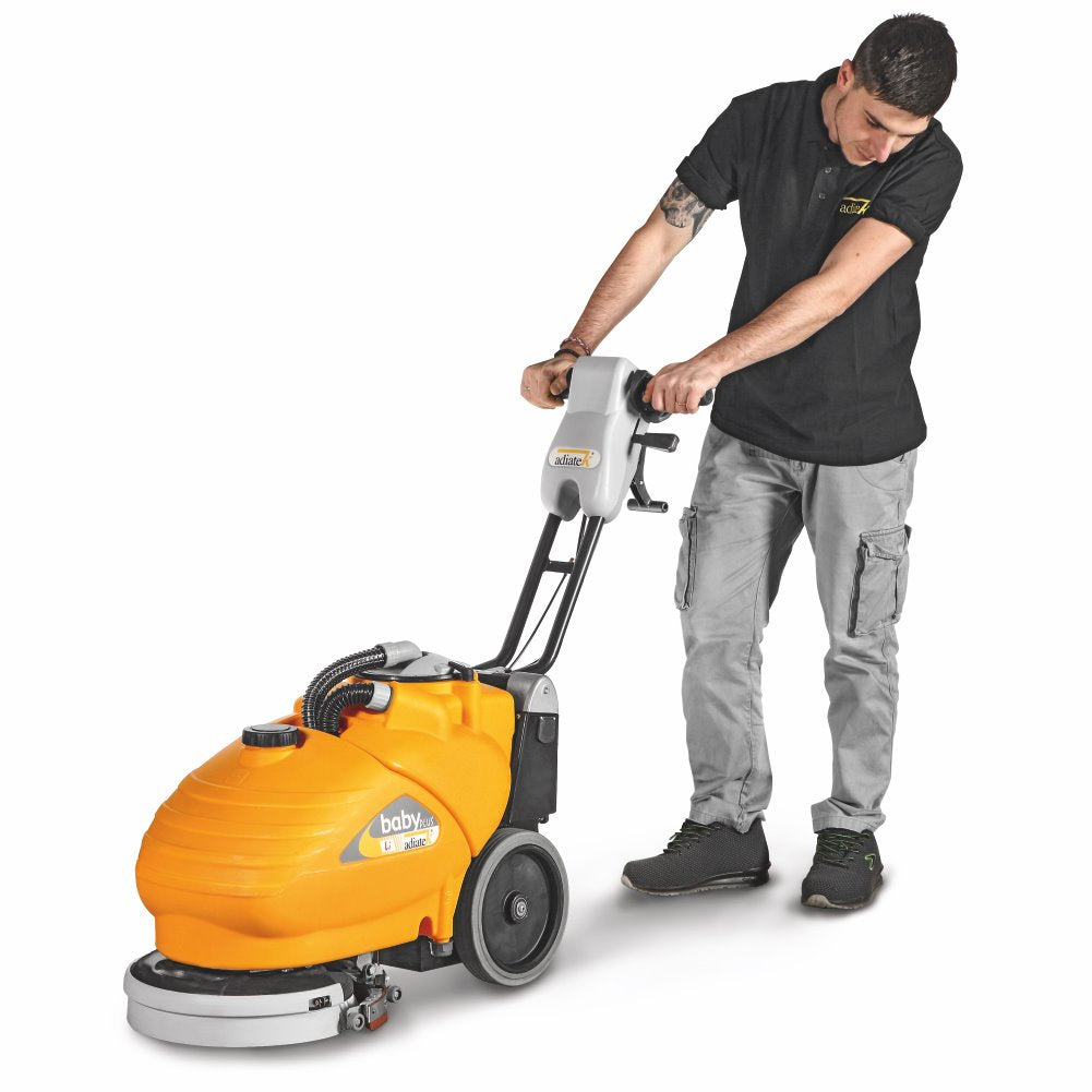 Person using an Adiatek Baby Plus Scrubber Lithium floor cleaning machine on a white background
