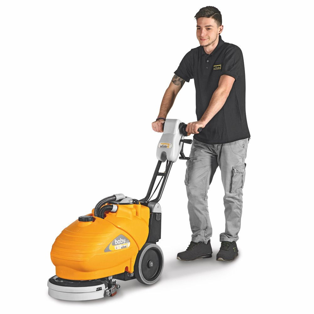 Person pushing an Adiatek Baby Plus Scrubber Lithium floor cleaning machine on a white background