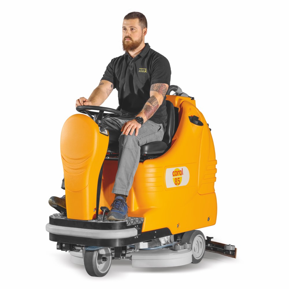 Man sitting on a Adiatek Coral 85 Ride On Auto Scrubber cleaning machine on a white background
