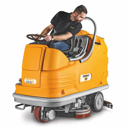 Person operating a yellow Adiatek Diamond 100p AC floor cleaning machine on a white background