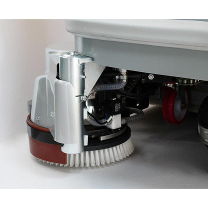 Close-up of a Adiatek Diamond 100s Ride On floor cleaning machine's brush and undercarriage on a white background