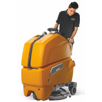 Person operating a large orange Adiatek Quartz 50 floor cleaning machine on a white background