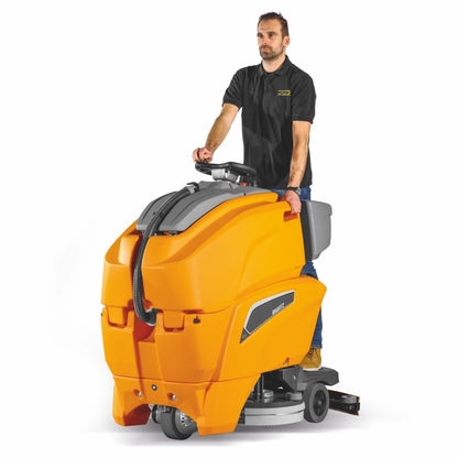 Person operating a large orange cleaning machine on a white background