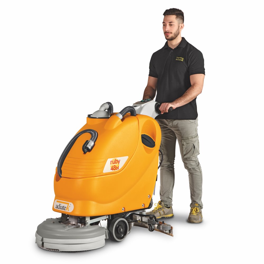 Person standing next to a Adiatek Ruby 48bl Traction Auto Scrubber cleaning machine on a white background