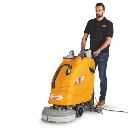 Man pushing a yellow Adiatek Ruby 48e Electric Auto Scrubber machine on a white background