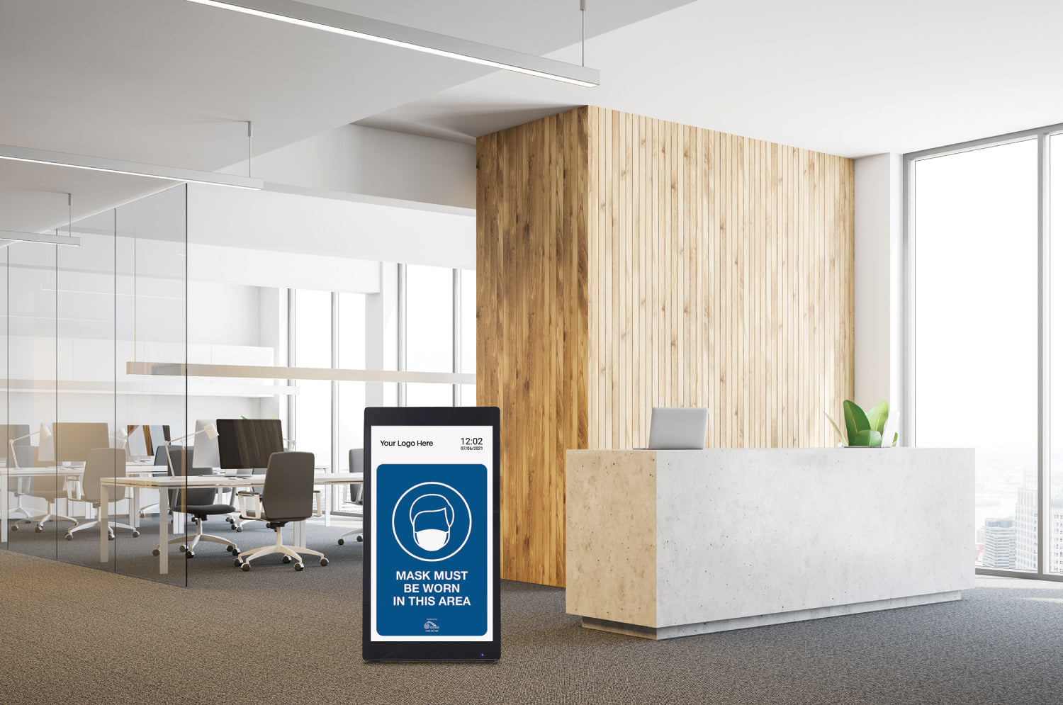 Digital display in a modern office with a mask-wearing reminder message.