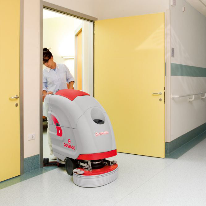 Floor cleaning machine in a hospital setting with a nurse in the background