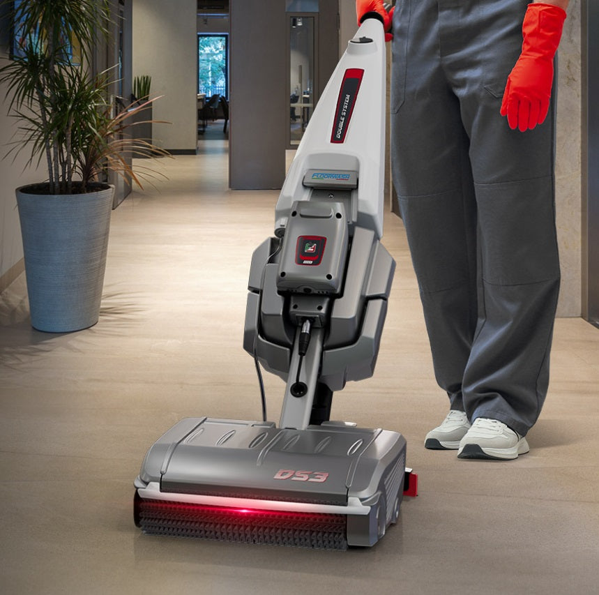 Person using a Floorwash DS3 floor cleaning machine in an indoor setting
