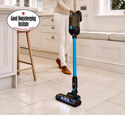 Person using a Halo Capsule X Stick Vacuum Cleaner in a kitchen with Good Housekeeping Institute approval badge.