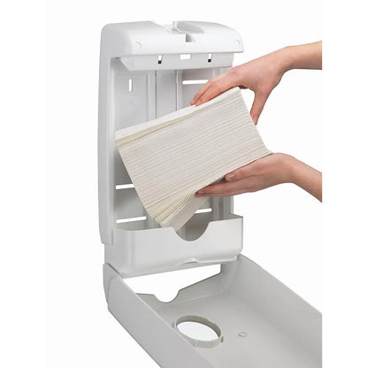White paper towel holder with a hand pulling out a roll of white paper towels.