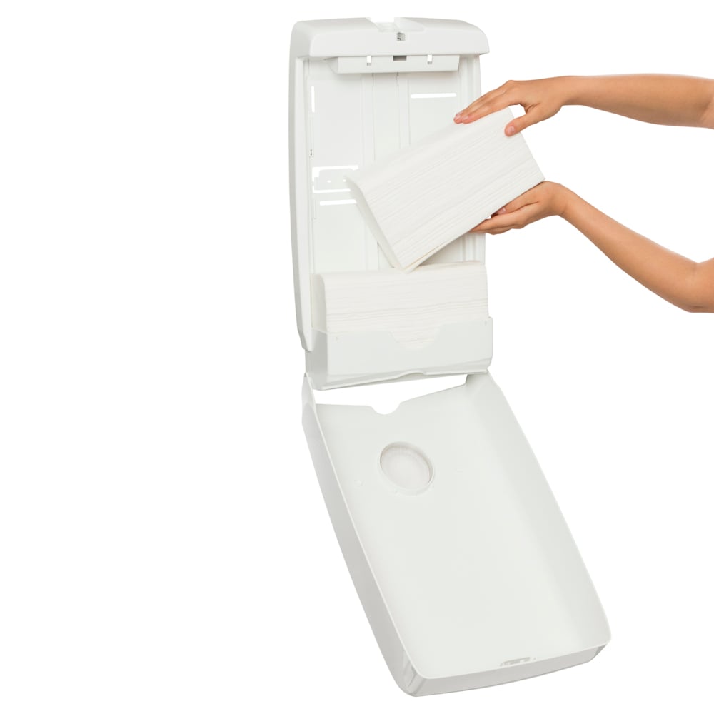 White paper towel holder with a hand taking a sheet of paper towel.