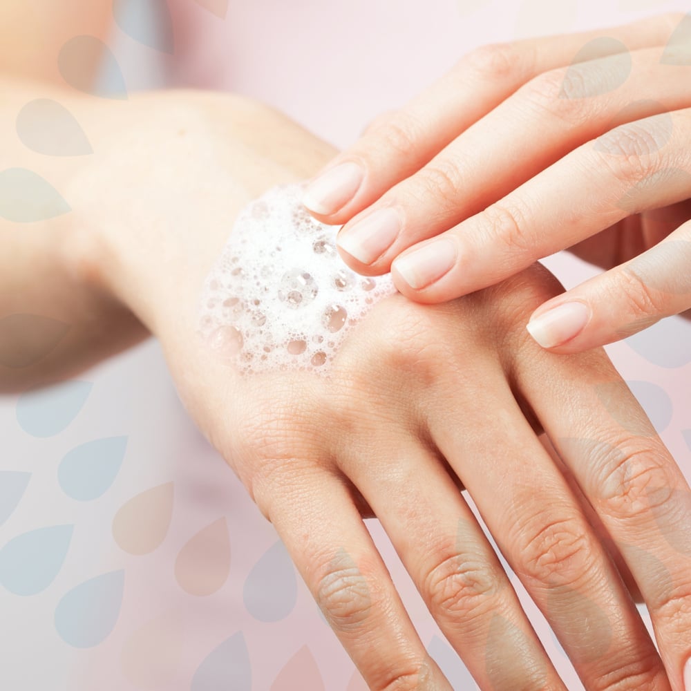 Close-up of hands with Kleenex Lux Hand soap bubbles on a soft background