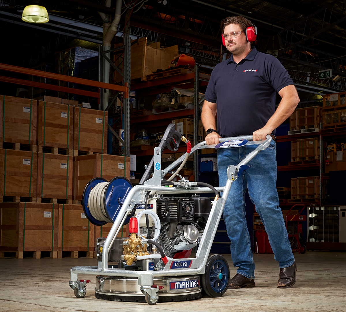 Man pushing Makinex Pressure Washer in a warehouse setting