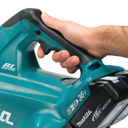 Hand holding a teal Makita Turbo Leaf Blower with close-up on the handle and trigger