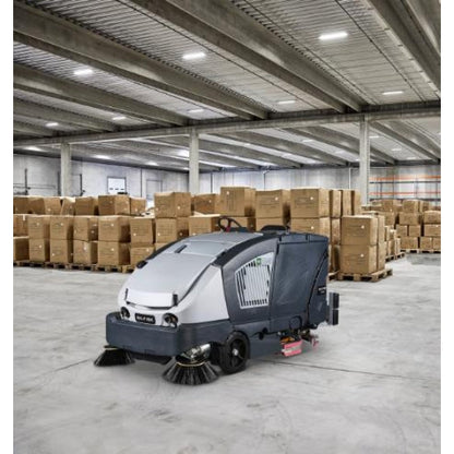 Nilfisk CS7020 Lithium Ion Sweeper Scrubber Dryer in a warehouse with stacked boxes