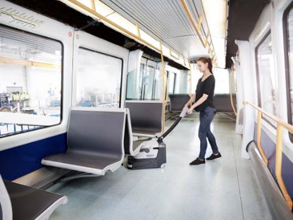 Person cleaning the interior of a modern train with a Nilfisk SC250 Scrubber.