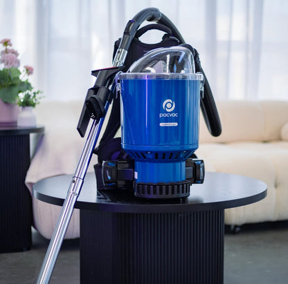 Blue Pacvac Superpro 700 vacuum cleaner on a table with a living room background
