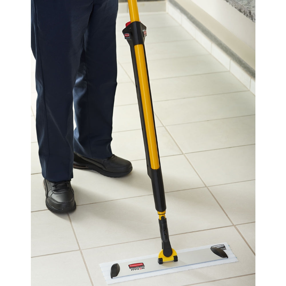Person using a floor cleaning tool on a tiled floor