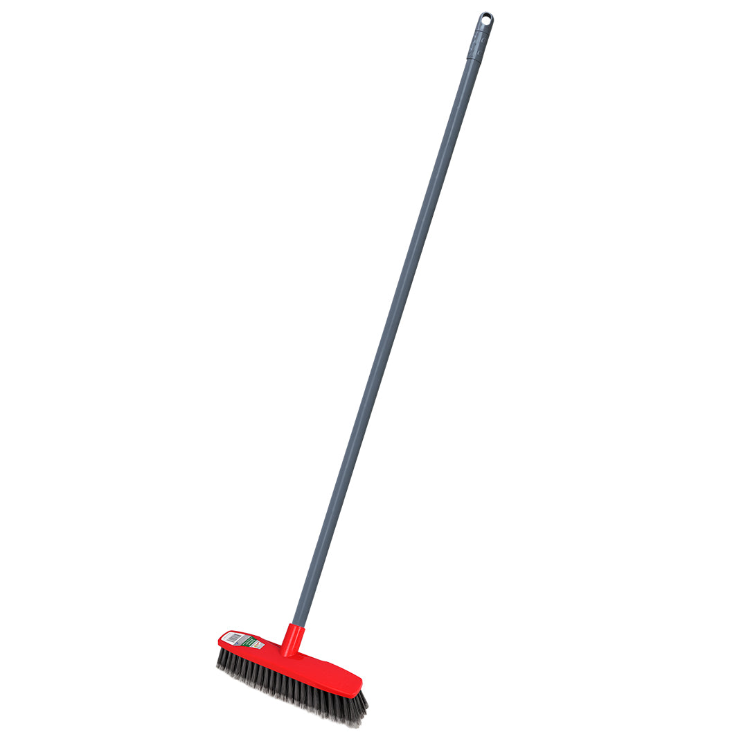 Red broom with a long handle on a white background