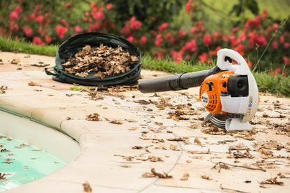STIHL Blower Z Petrol leaf blower on a patio with leaves and flowers in the background