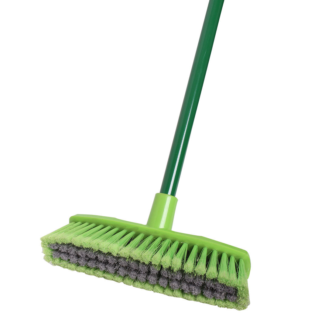 Green broom with a scrubber head on a white background