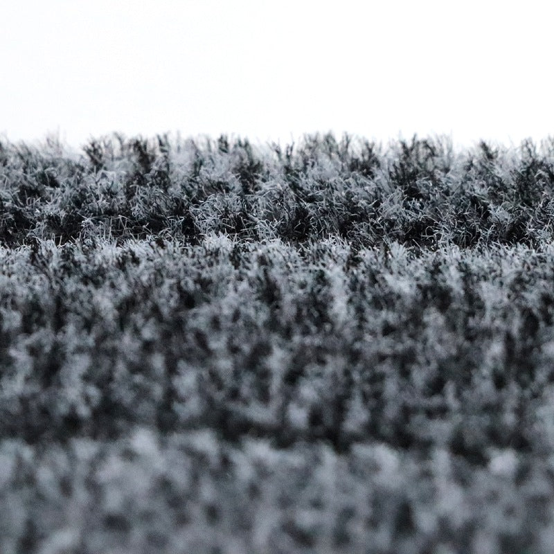 Close-up of a textured black mop pad surface with a blurred background