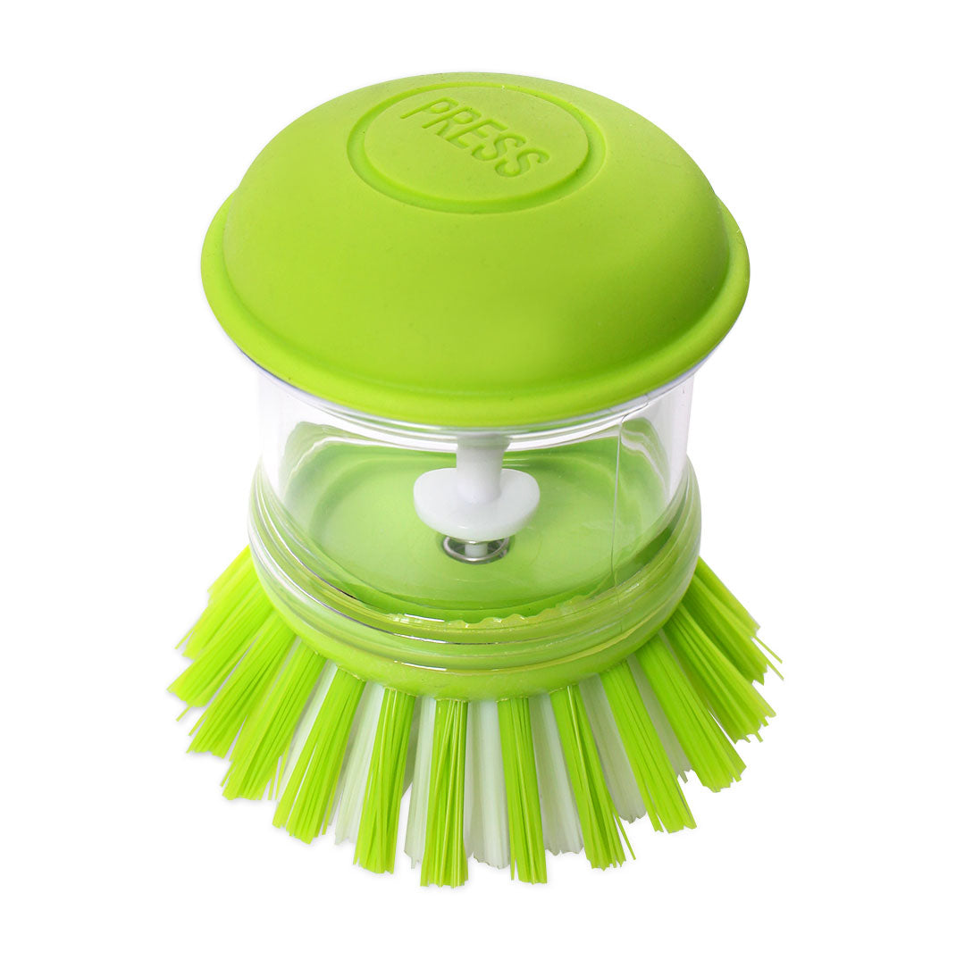 Green dish scrubber with a clear handle on a white background