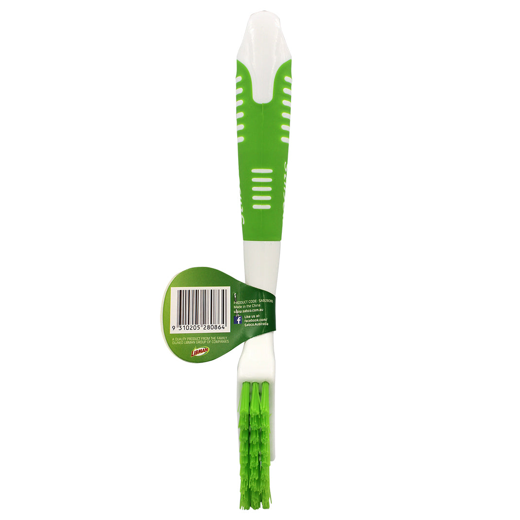 Green and white cleaning brush with a label on a white background