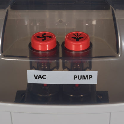 Two red buttons labeled 'Vac' and 'Pump' on a machine.