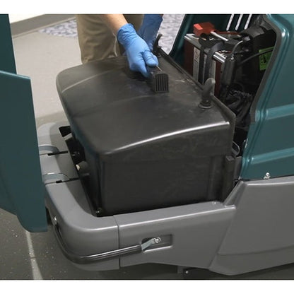 Person wearing gloves removing a black battery cover on a Tennant S7 Battery Sweeper